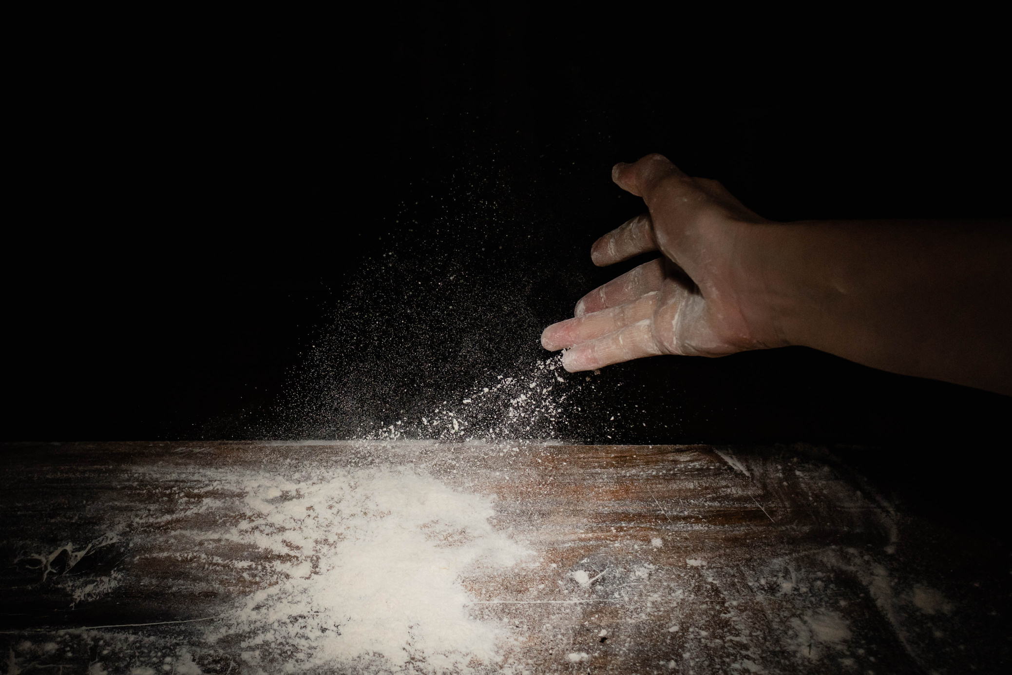 Hand Throwing Out Flour